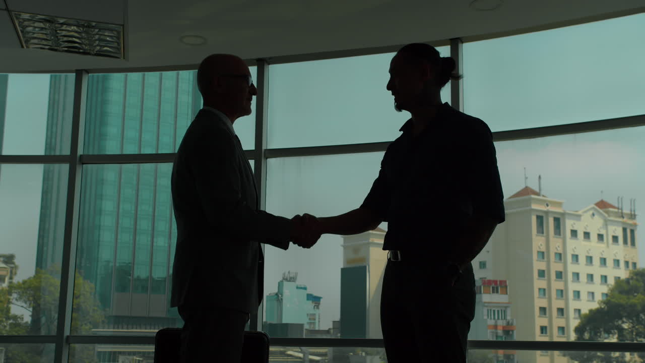 Silhouettes of Businessmen Meeting at Office
