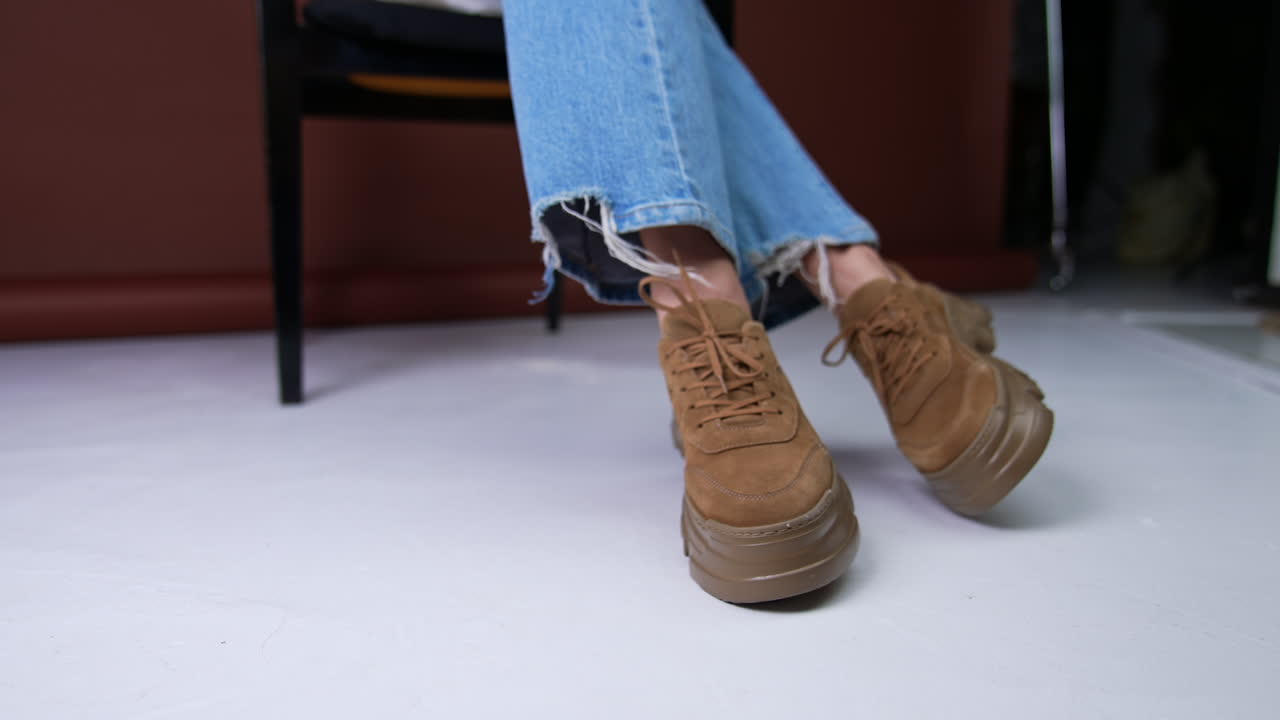 Woman's brown platform sneakers with denim jeans