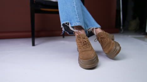woman's brown platform sneakers with denim jeans