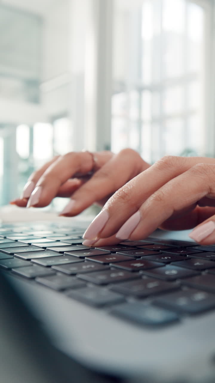 Close-up of Woman's Hands Typing on Laptop Keyboard