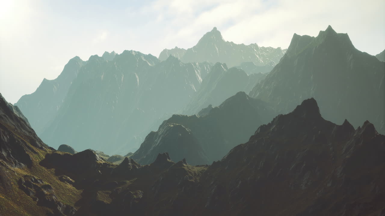 Majestic mountain range bathed in soft sunlight during early morning hours