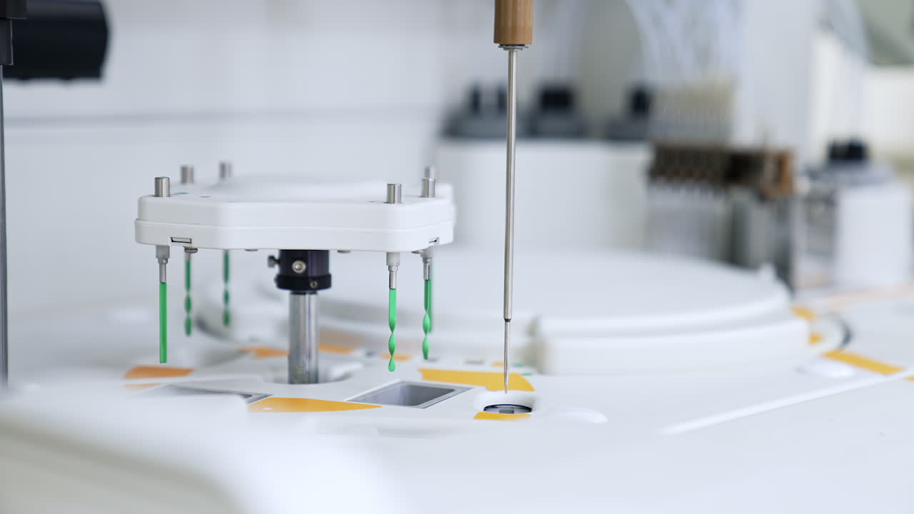 Long metal needle moving from one slot to another. Advanced equipment working in the science laboratory for blood test.