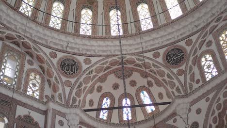 interior of a mosque dome with intricate design and stained glass windows