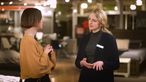 a customer and sales associate discuss phone inspiration inside a store