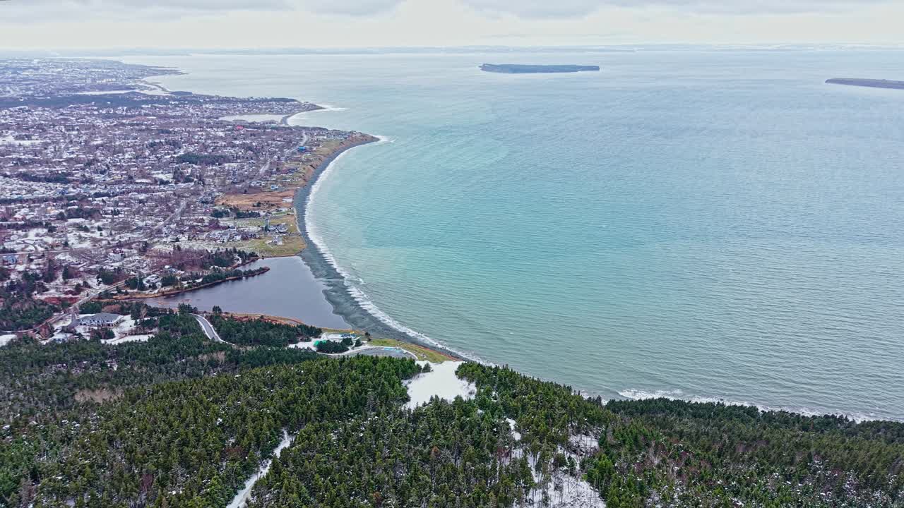 Drone footage shows rugged cliffs and rolling ridges with orange and green foliage