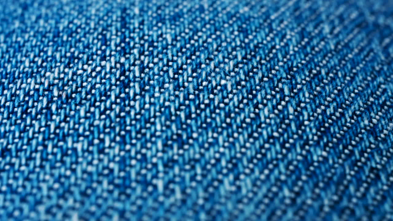 Close up of blue denim fabric texture showing fine threads and detailed textile pattern