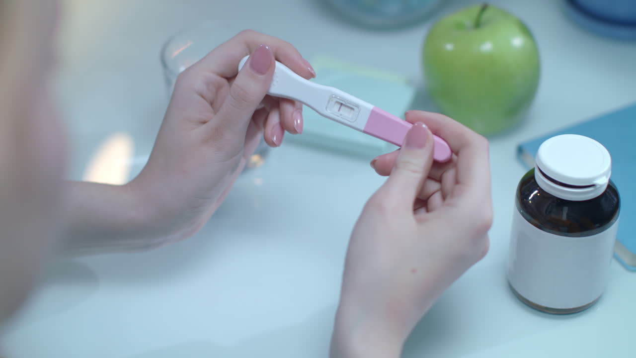 Positive pregnancy test in female hands. Test pregnacy with one line