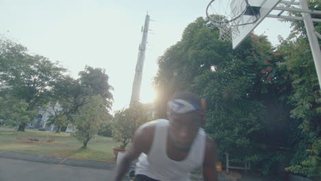 black basketball player dribbling ball on camera outdoors