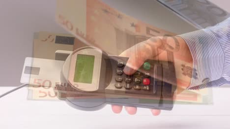 Animation-of-euro-banknotes-falling-over-hand-of-caucasian-man-holding-payment-terminal