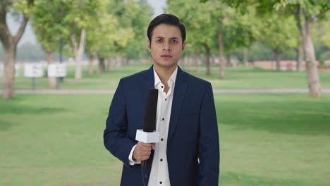 angry indian reporter looking to the camera