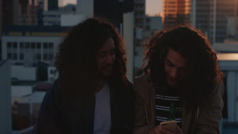 young hipster friends taking selfie photos on rooftop at sunset enjoying hanging out together drinking alcohol sharing friendship in urban city skyline background