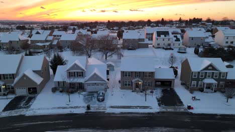 modern neighborhood during snowy sunset