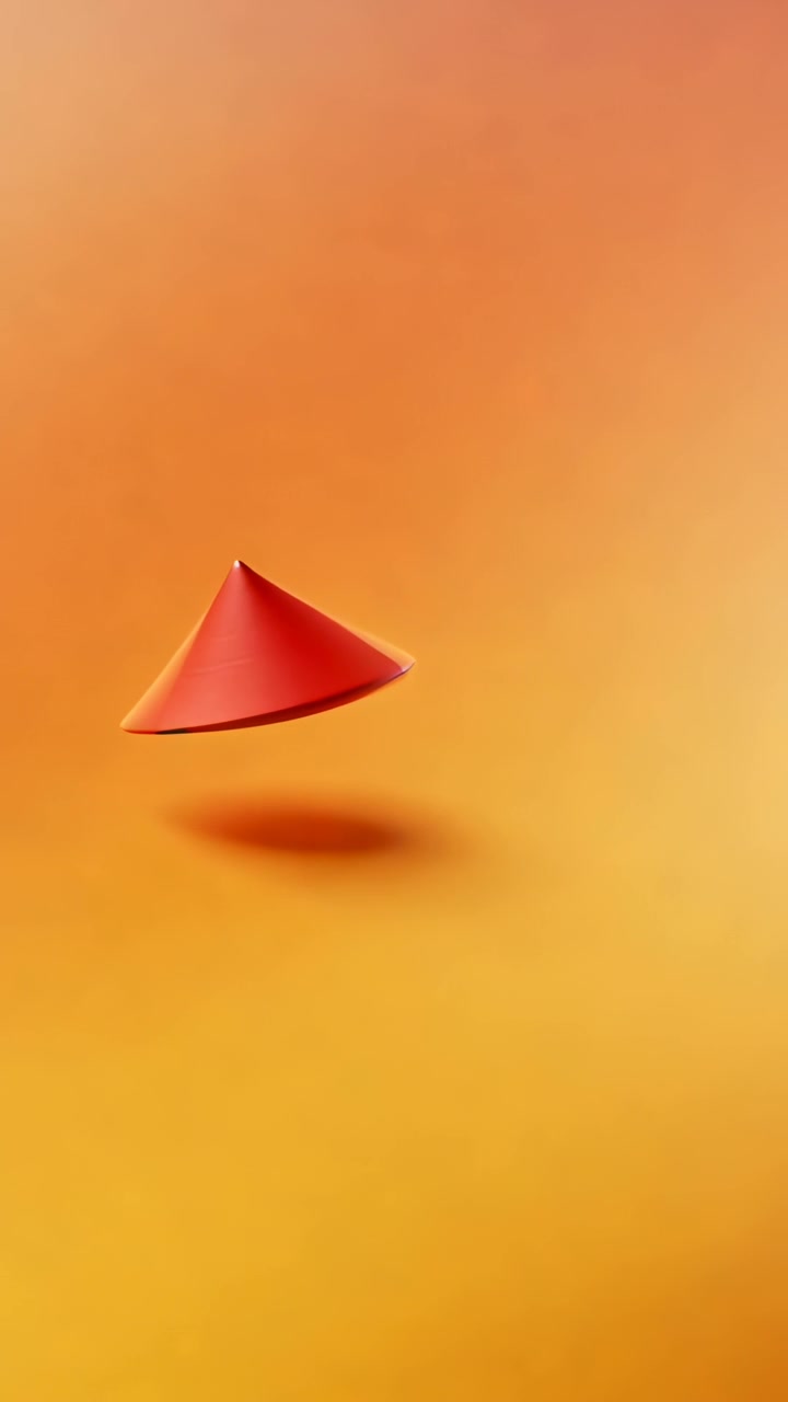 Video verticale: Cono rosso che inizia a salire, girando su una sfumatura calda, mostrando effetto hover e ombra