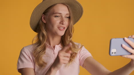 Caucasian-woman-in-a-hat-having-video-call-on-smartphone.