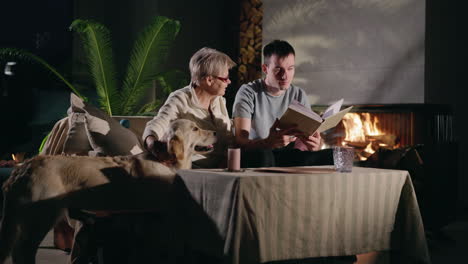 grandmother, grandson, and dog by fireplace enjoying a cozy evening.