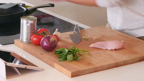 man follows recipe on digital tablet in kitchen shot on r3d