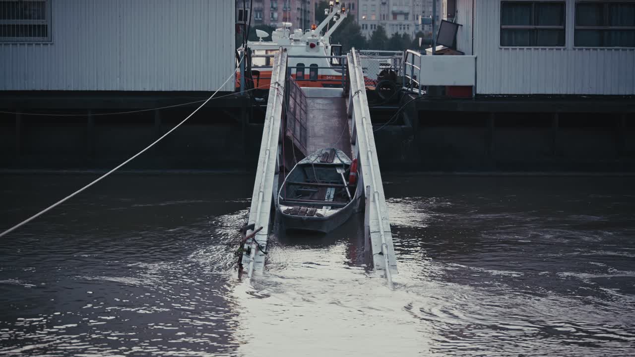 boat is docked on a flooded pier, with water surrounding its ramp on the Danube