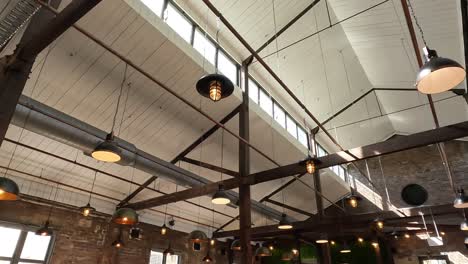 warm industrial style interior of a converted warehouse with various hanging lights