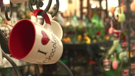 i love chocolate coffee mugs for sale at indoor flea market, panning view angle, stuttgart, germany, balvaria europe