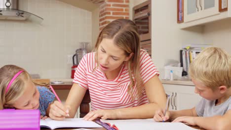 mother helping children doing homework