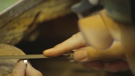 italian goldsmith at work building an engagement or a wedding ring