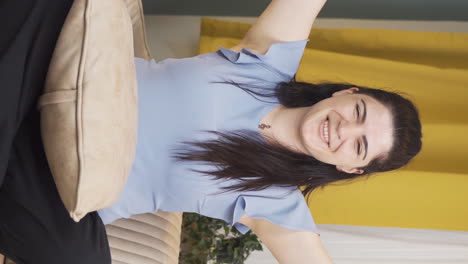 Vertical-video-of-Woman-experiencing-joy-looking-at-camera.