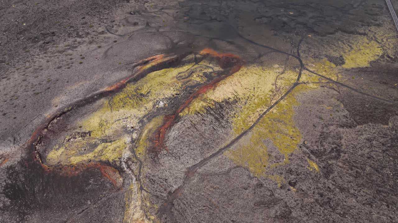 Aerial View Of Volcanic Landscape With Yellow Sulfur Deposits Across Dark Textured Ground. Timanfaya National Park In Lanzarote, Spain