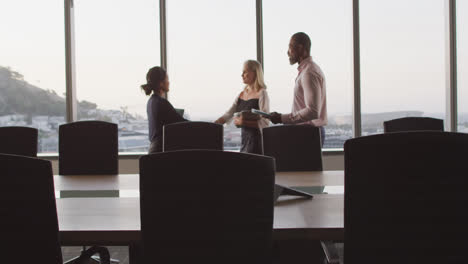 professional businesspeople shaking hands in modern office in slow motion