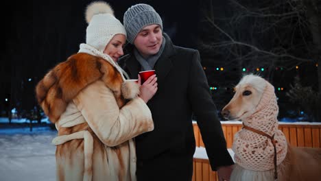 couple and dog enjoying a winter evening