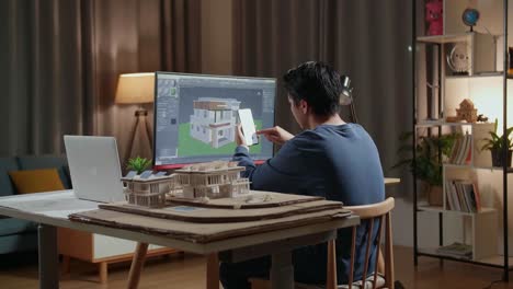 arquitecto trabajando en el diseño de la casa por la noche