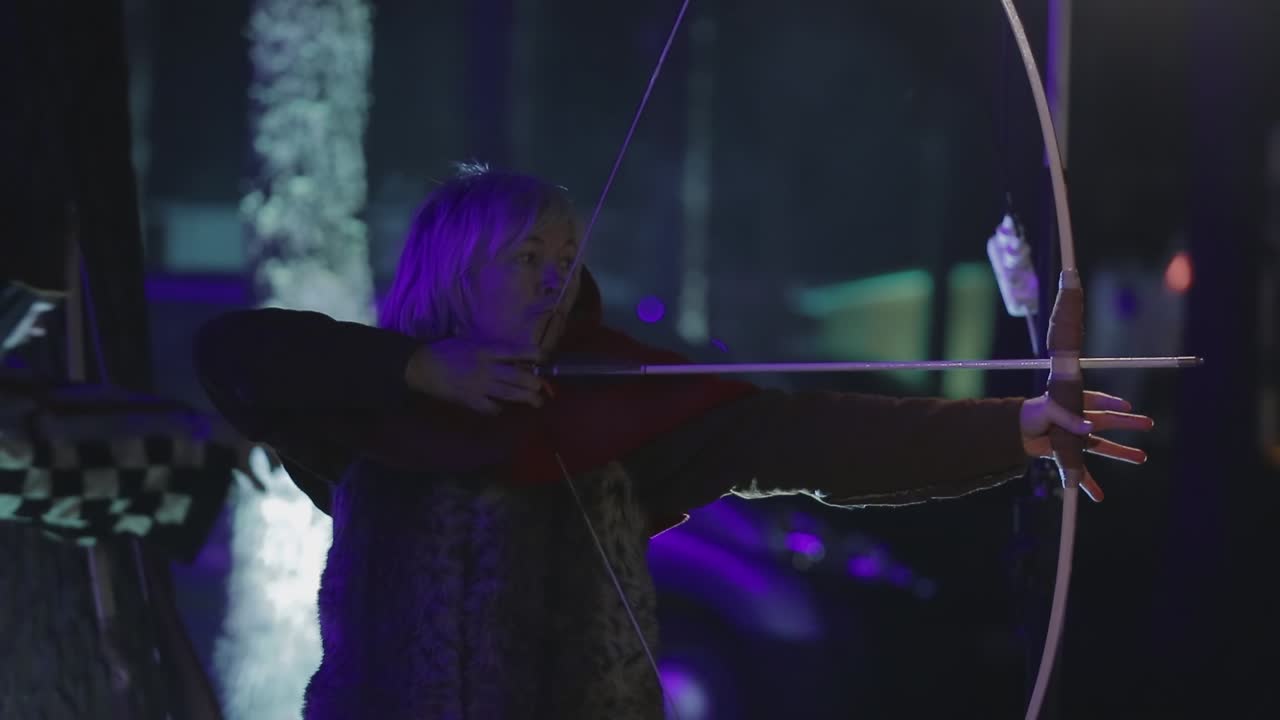 Female Archers On A Medieval Fighting. VINNITSA, UKRAINE, MARCH 2017: medieval archer while shooting a flying arrow