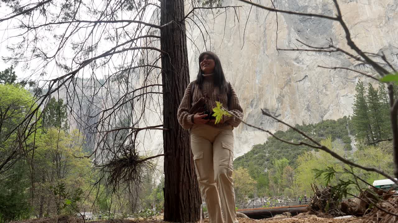 Woman with Backpack and Camera Enjoying a Mountain Landscape