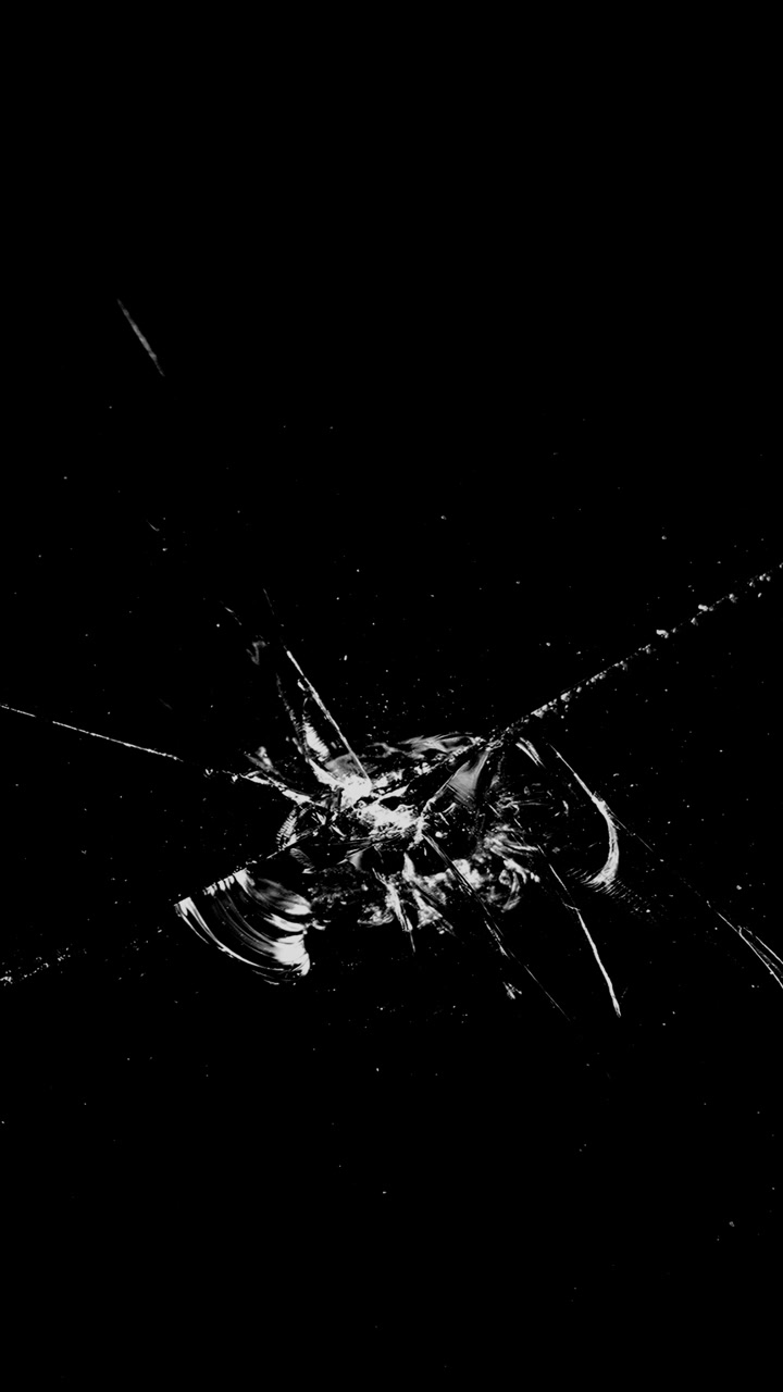 Glass shatters in an instant from a central impact. A dynamic vertical overlay for action sequences, explosions, or creating a dramatic breaking effect