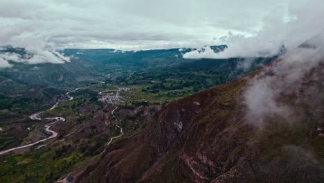 drone reveals maca village, passing pachamarca mountain, with chivay in the background