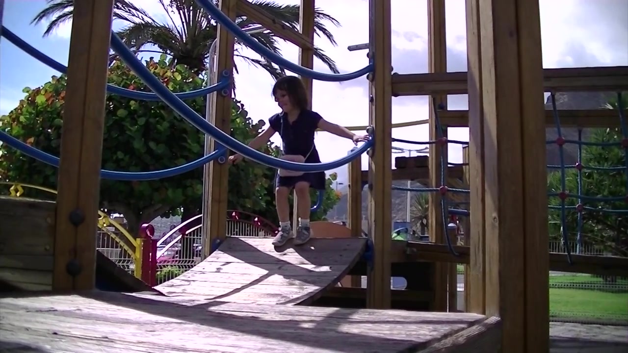 Three year old girl playing outdoors and having fun