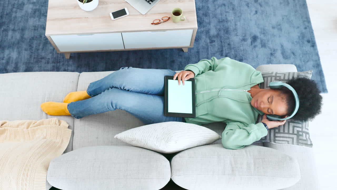 Green screen of a tablet on a woman lying