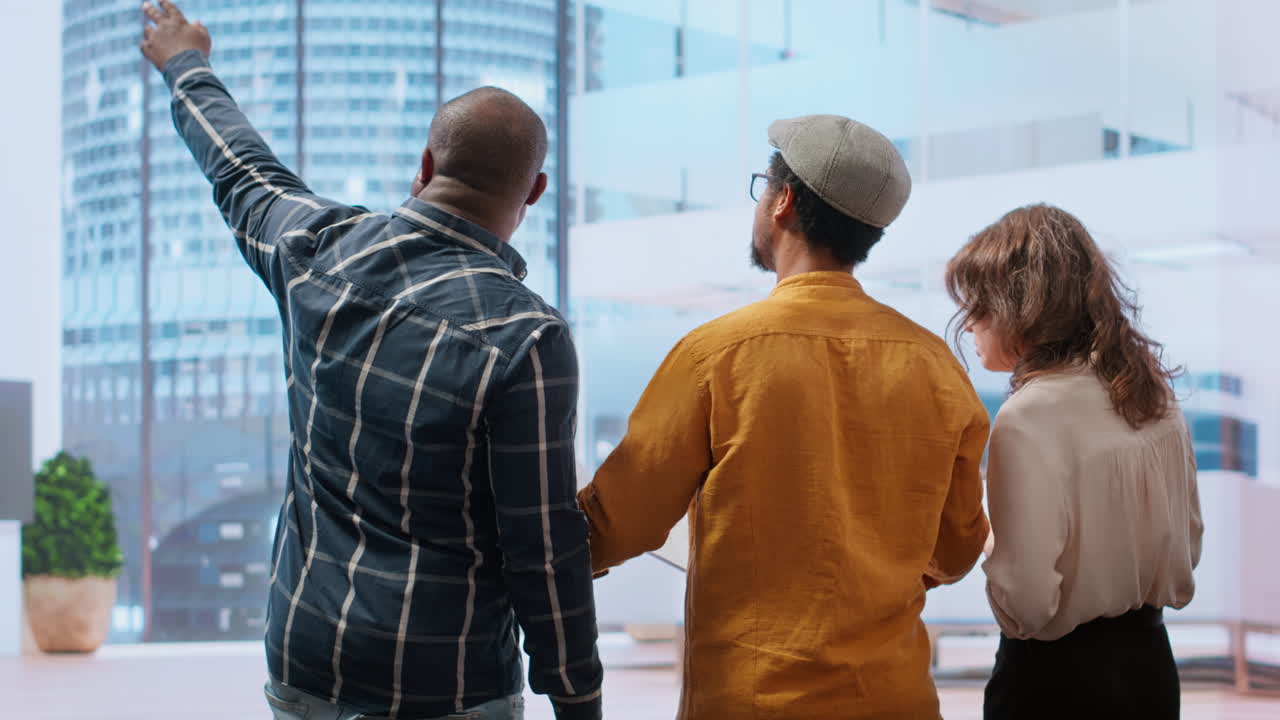 Real estate agent showcasing modern office blueprints to clients