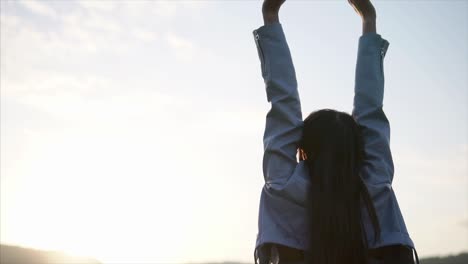 woman stretching outdoors at sunset