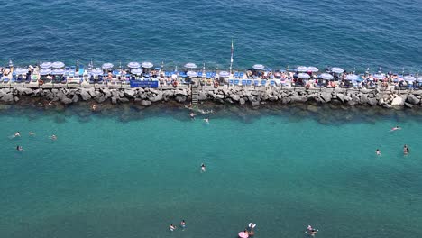 people enjoying a swim by the shore