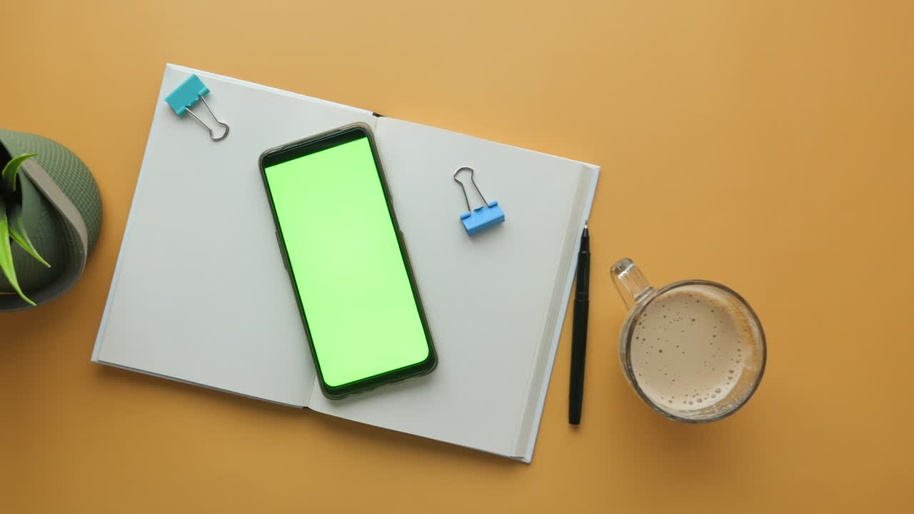 Open Notebook with Smartphone, Coffee, and Office Supplies