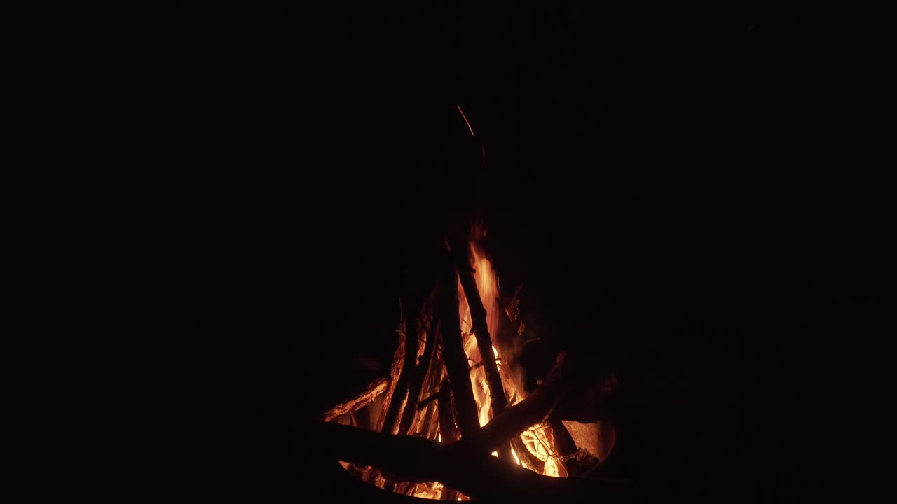 calm campfire slowly burning in the dark night in 4k 29.97p