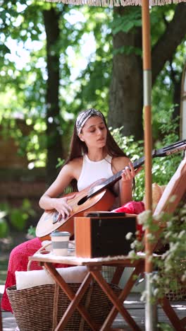 woman playing guitar outdoors