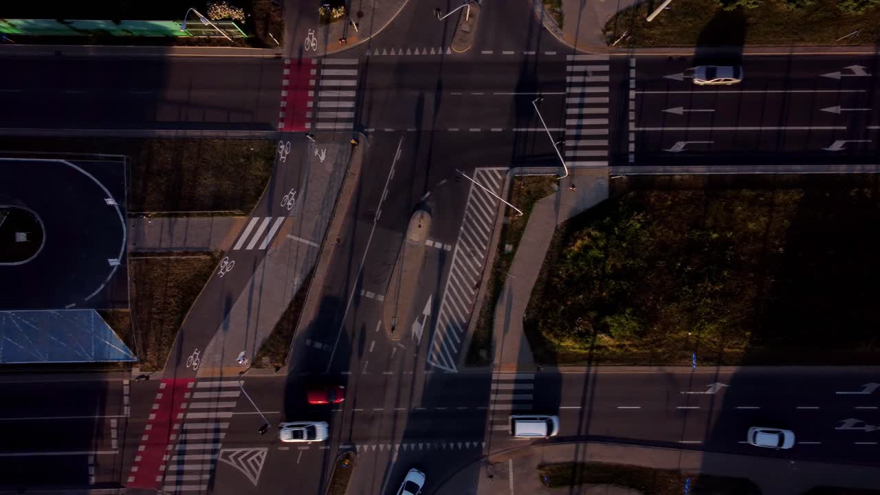 street junction in the middle of the busy city with cars driving