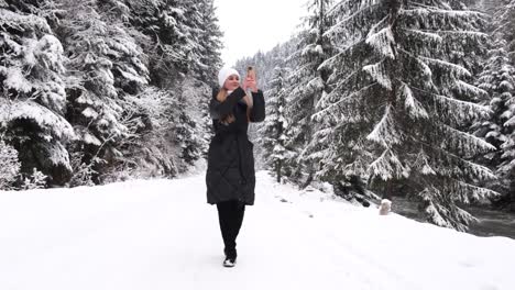 footage of goodlooking young woman walking in beautiful snowed forest with boyfriend in winter day footage of goodlooking young woman walking in beautiful snowed forest with boyfriend in winter day man giving hand and helping girl to climb couple enjoying date in nature mountains