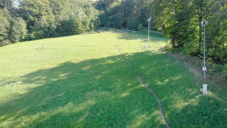 Fly-over-green-grass-slope-of-fun-Bobkart-summer-toboggan