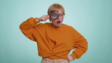 investigator researcher woman with magnifying glass near face, looking into camera with big zoom eye