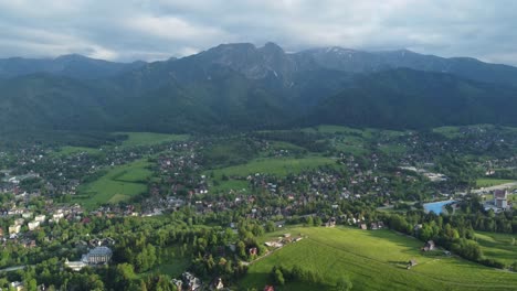 valley view from gubałówka - landscape flyover of snowcapped polish tatry mountains, farmland, forests, and legendary giewont peak near zakopane, poland - 4k 30fps smooth tracking forward-2