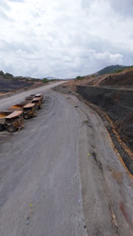 open-pit gold and silver mine, barrick gold, cotui, dominican republic. aerial drone fpv. vertical format, copy space