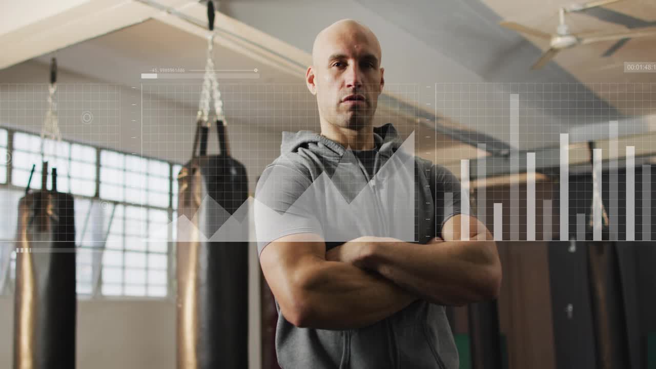 Male coach standing in boxing gym, frames progressing causing HUD, graphs, map showing training