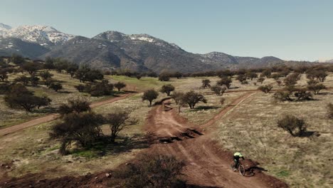 tracking shot of a moutain biker in a bike park, uhd 4k aerial